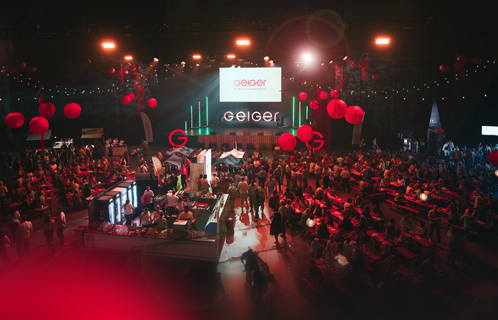 Publikum und Cateringbereich in der festlich beleuchteten Eventhalle beim Geiger-Mitarbeiterevent.