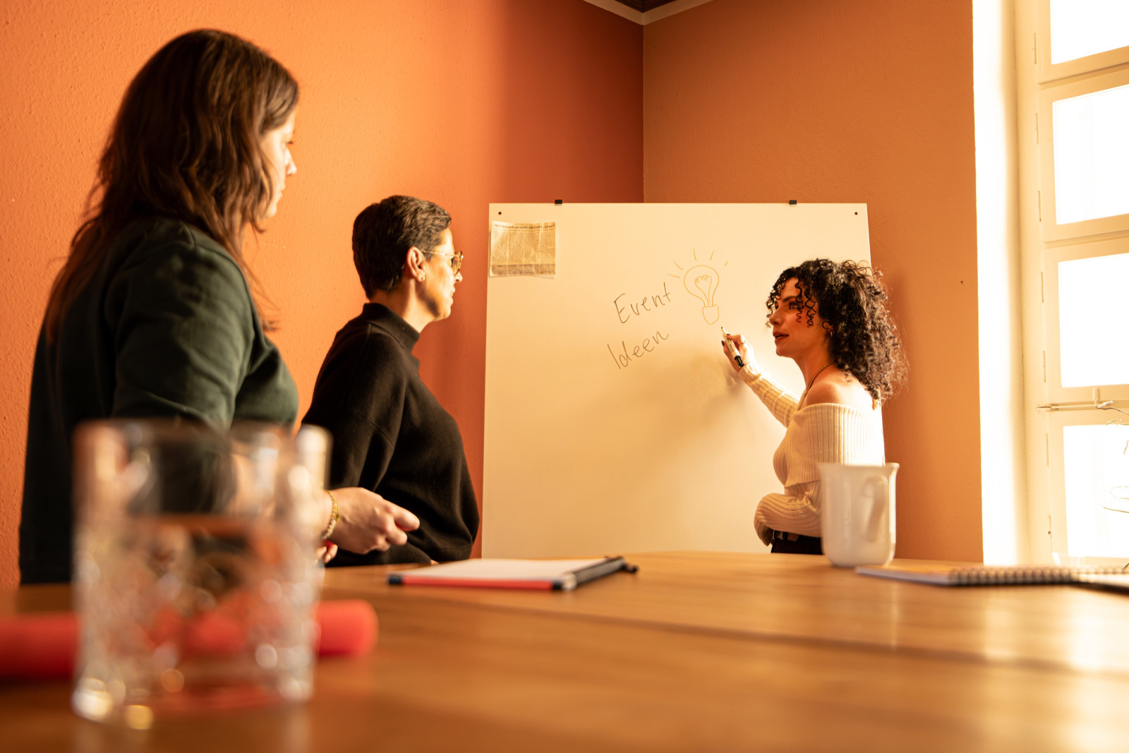 Team planning a marketing campaign at a whiteboard