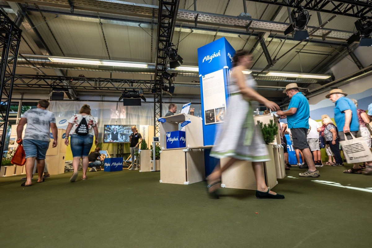 People move through the openly designed Allgäu presentation at the festival week.