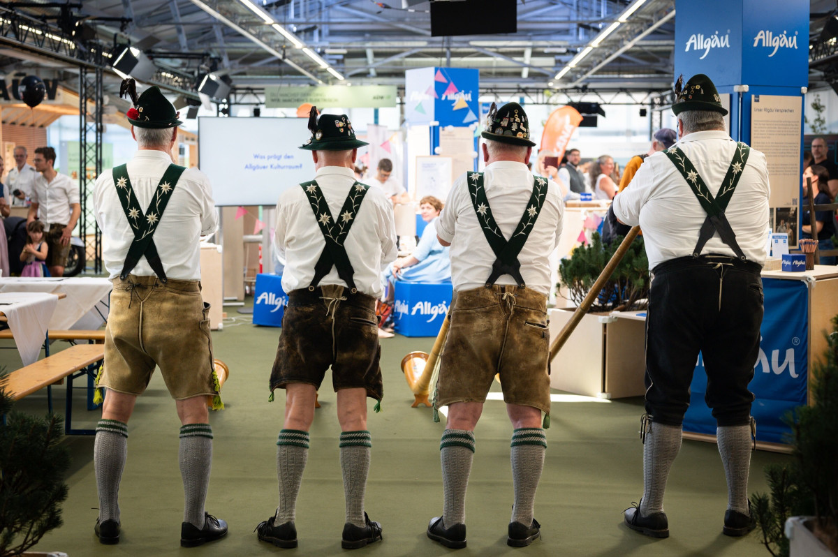 Alphorn players stand at the Allgäu booth during the festival week and perform a concert.