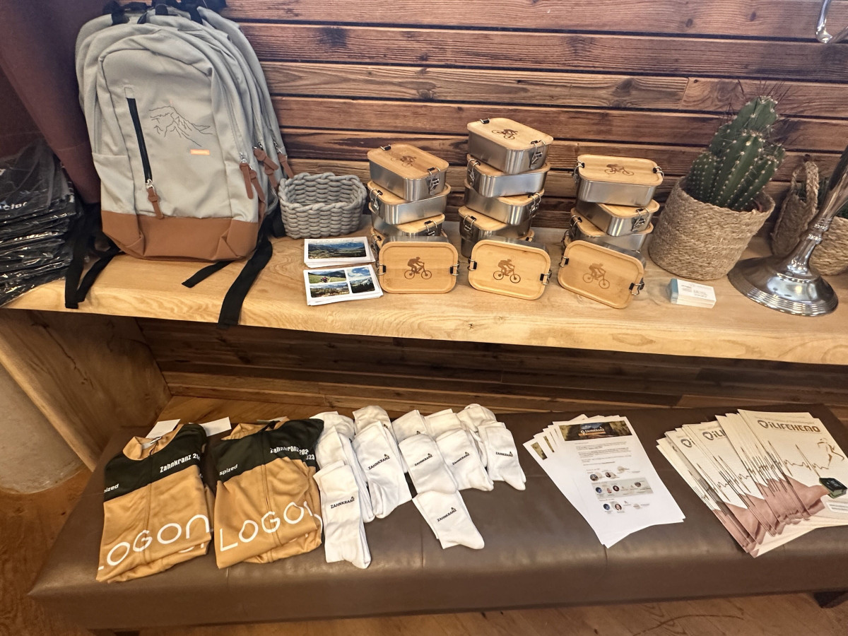 Giveaways and event materials arranged on a wooden table.