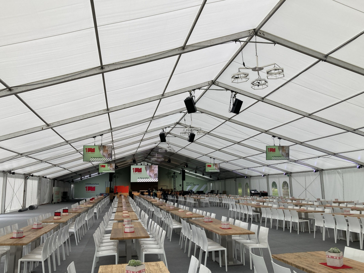 Interior view of a festival tent with seating and stage.