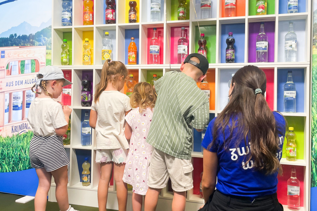 Families take part in the memory game together while the booth team assists them.