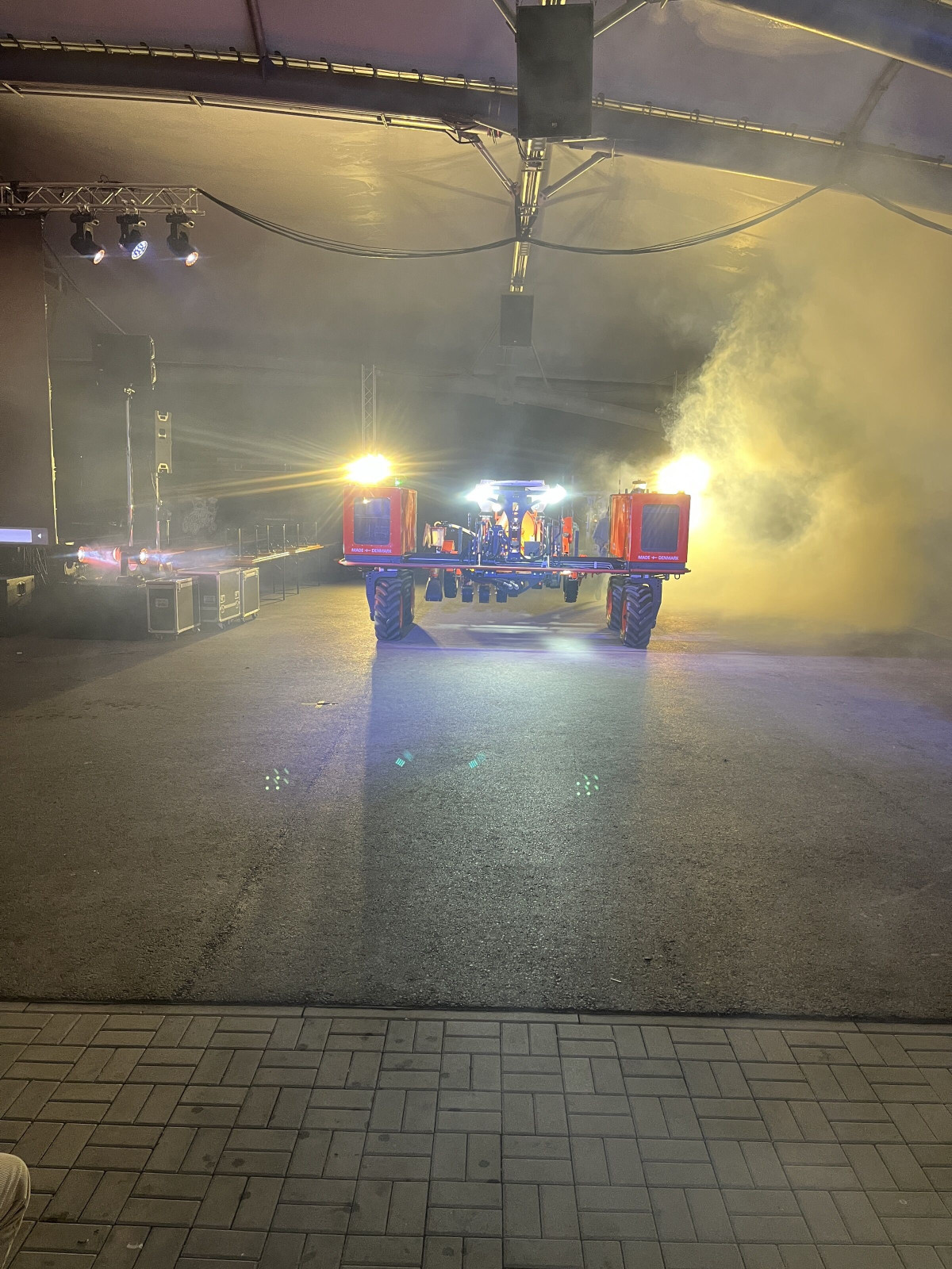 A machine drives through the hall as part of the staging at the dealer conference.