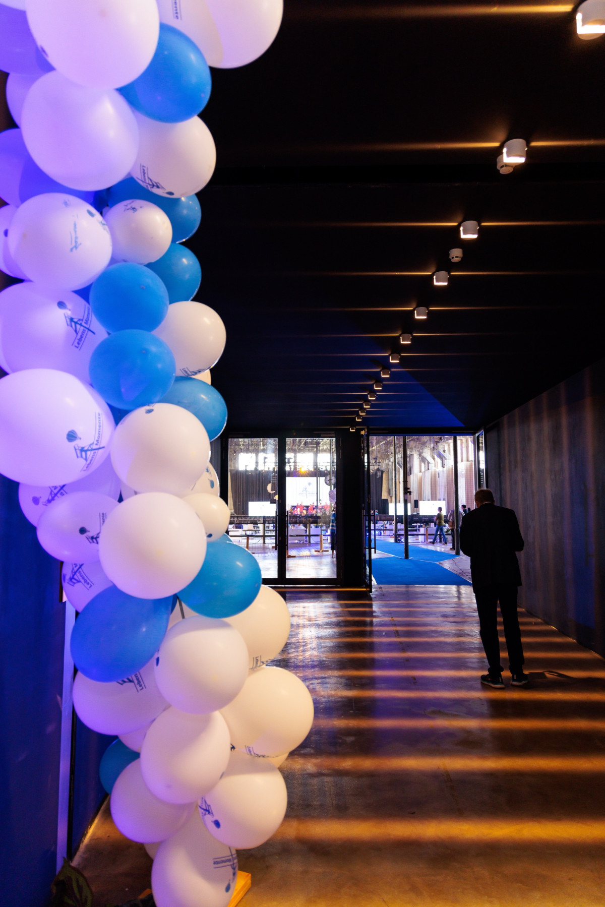 A balloon garland at the entrance welcomes guests.