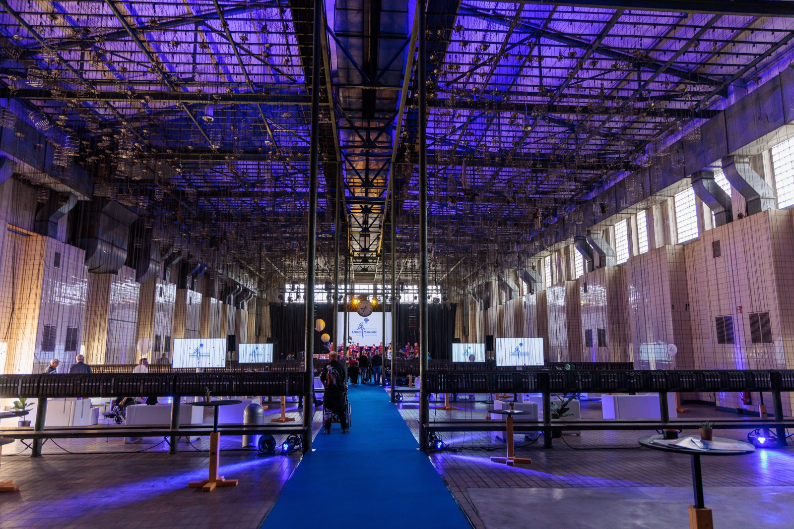 Lebenshilfe cultural festival at Zeche Ewald with illuminated industrial architecture and audience.