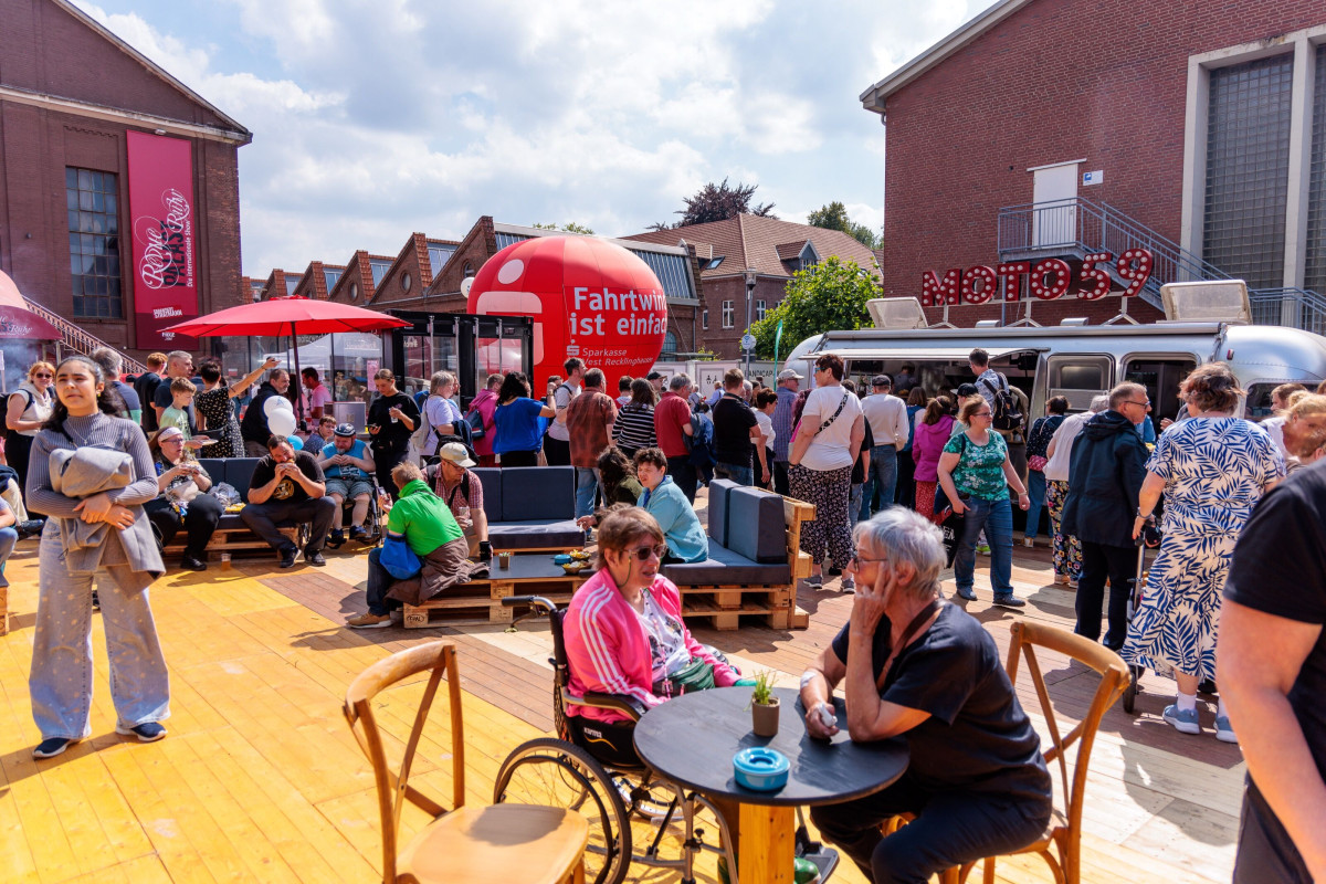 Visitors chat in the outdoor area.