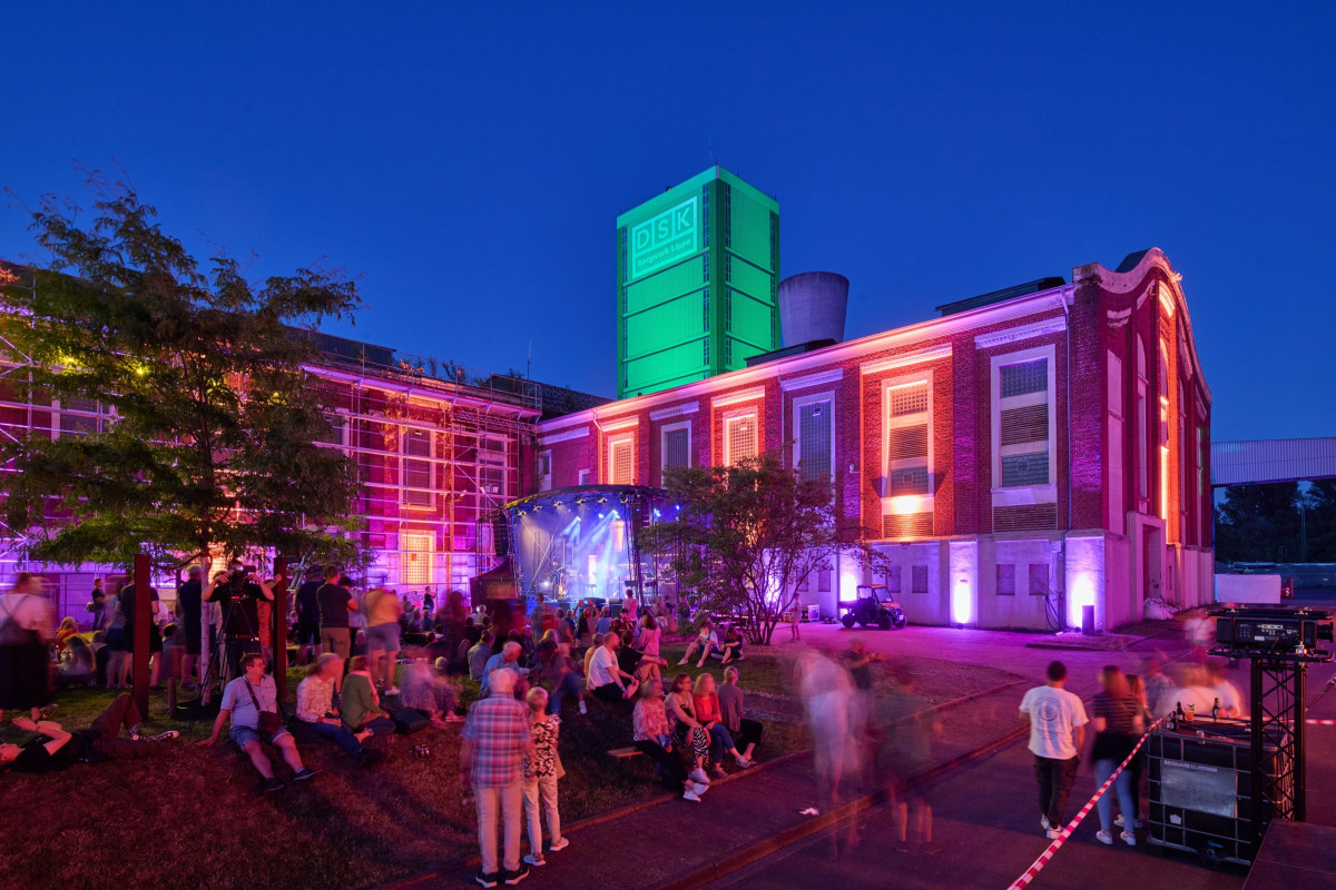Audience gathers in front of the open-air stage on the colliery grounds.
