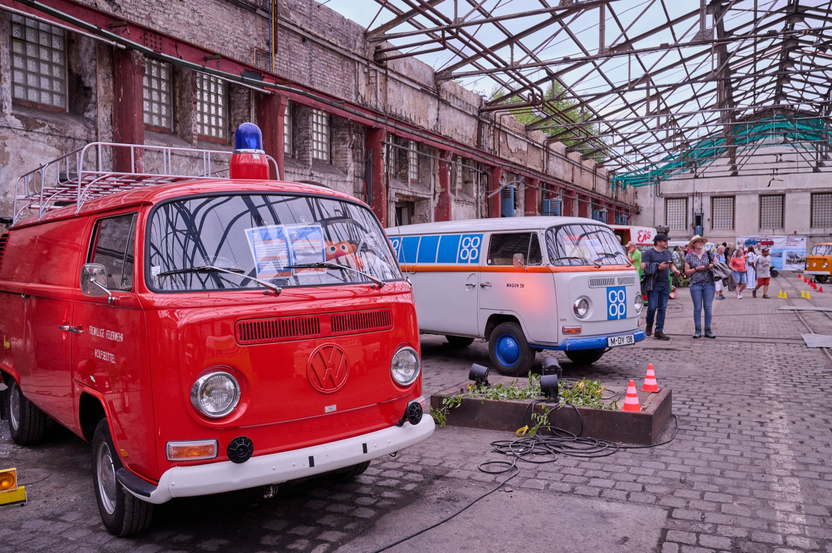 Historic industrial backdrop with nostalgic VW vans at Neue Zeche Westerholt lit for ExtraSchicht.