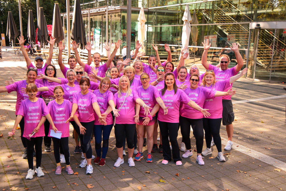 Large group of participants posing and smiling after the run together.