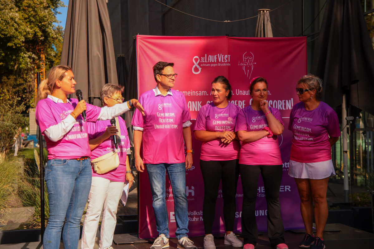 Participants stand together on stage and enjoy the award ceremony.