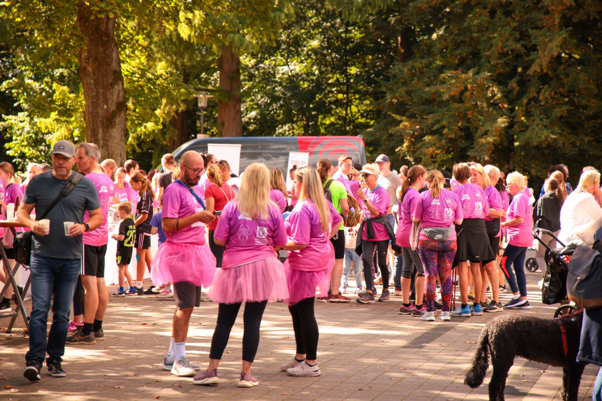 Participants stand in small groups and chat after the run.
