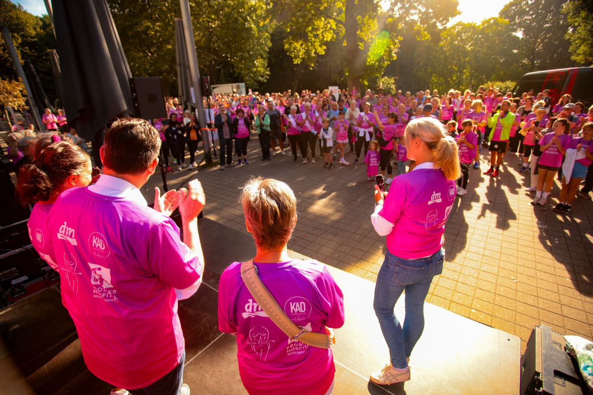 Participants stand together on stage and look out at the audience.