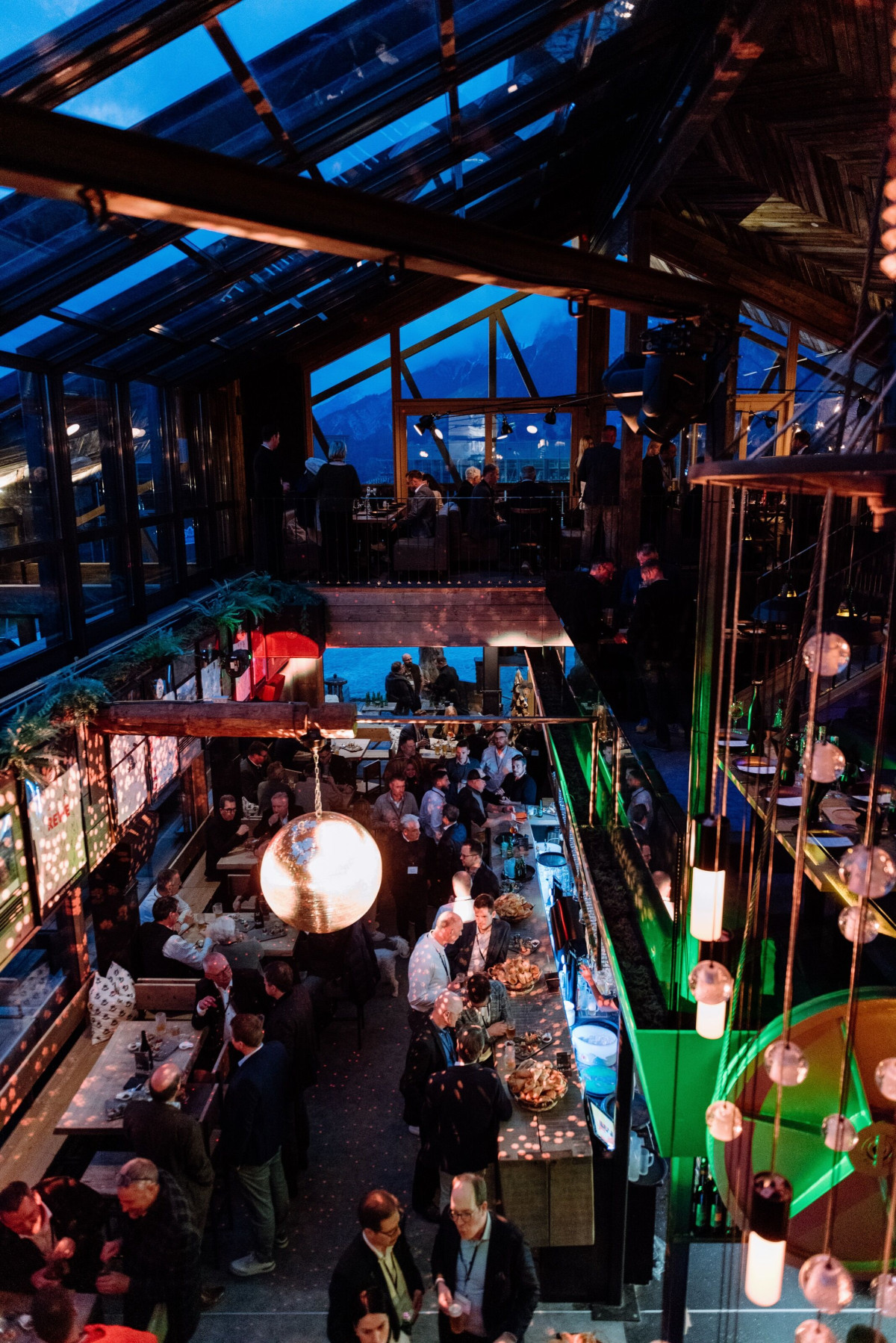 Evening event with guests in an illuminated indoor venue.