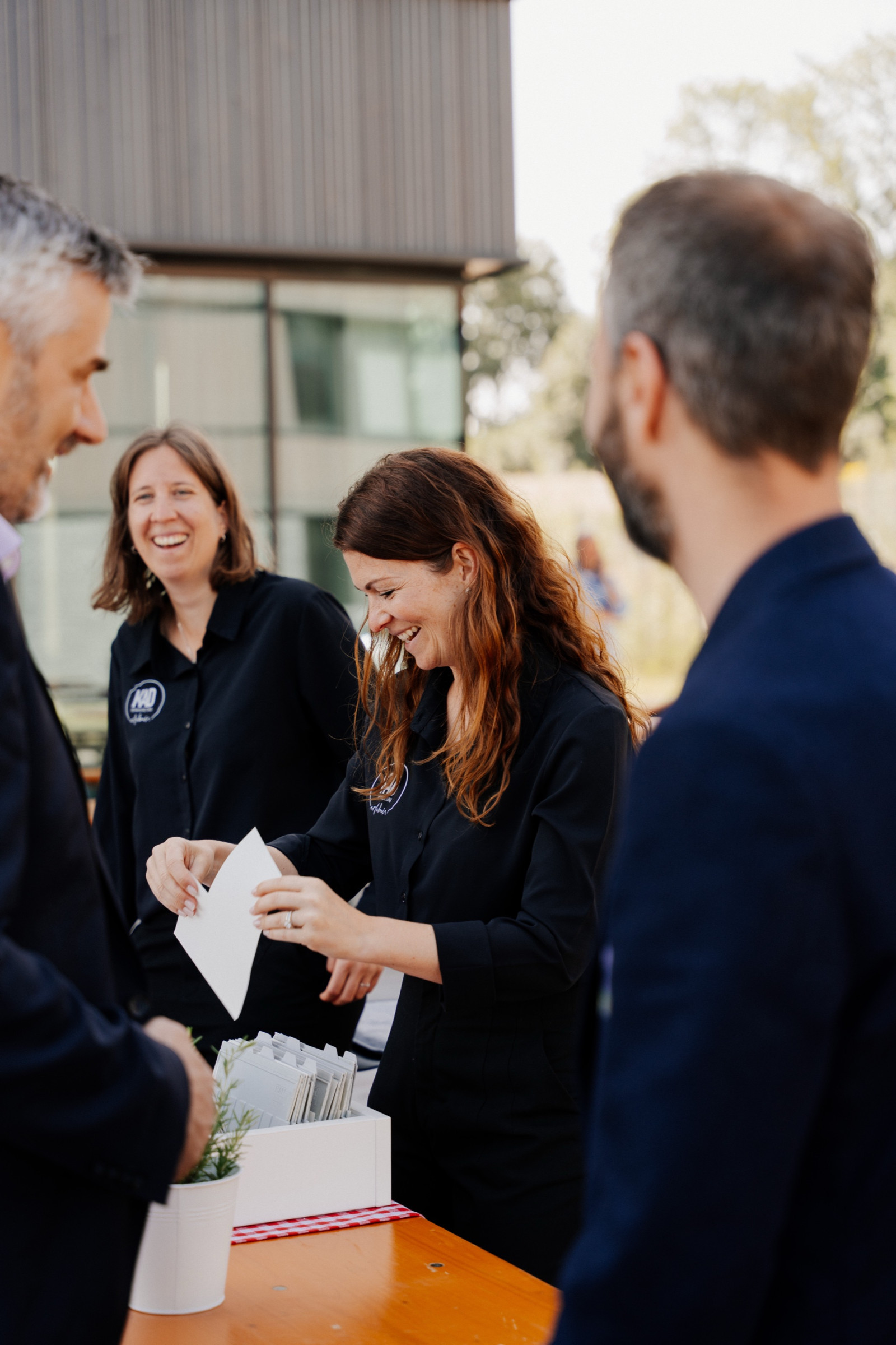 Distribution of materials during attendee management at an event.