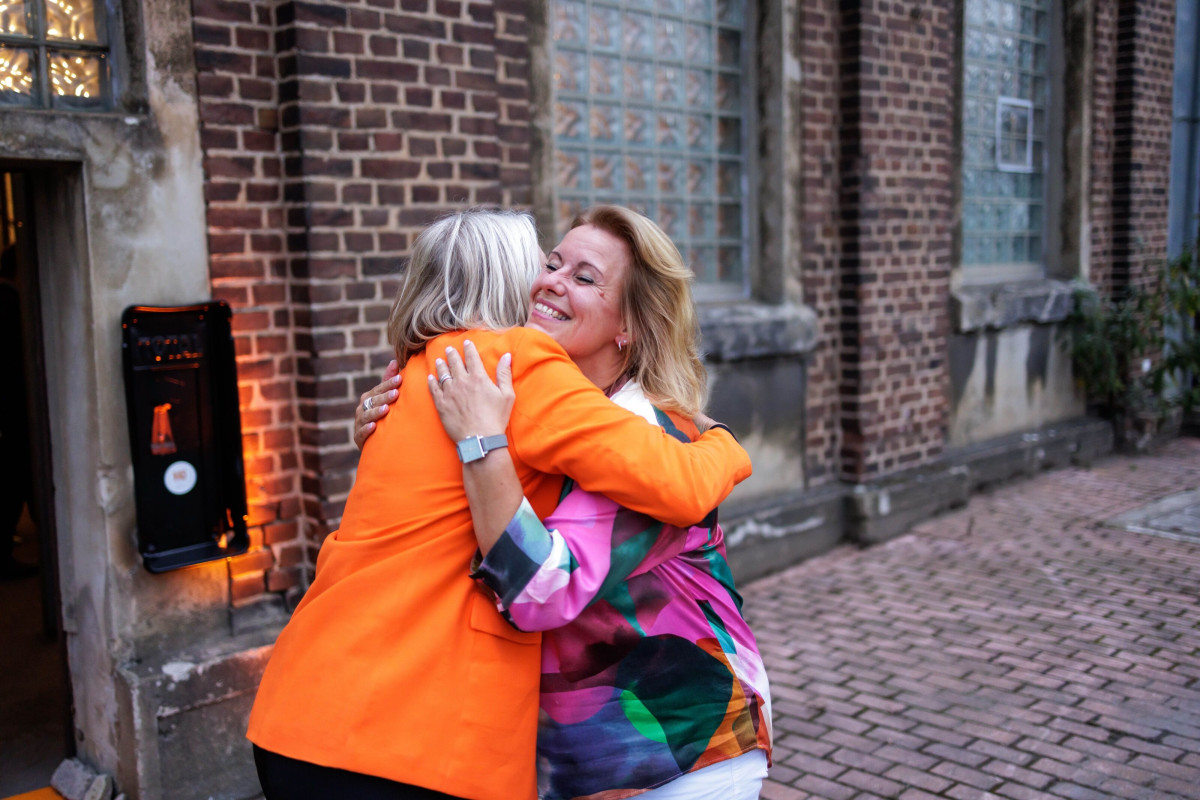 Warm welcome with a hug at an anniversary event.